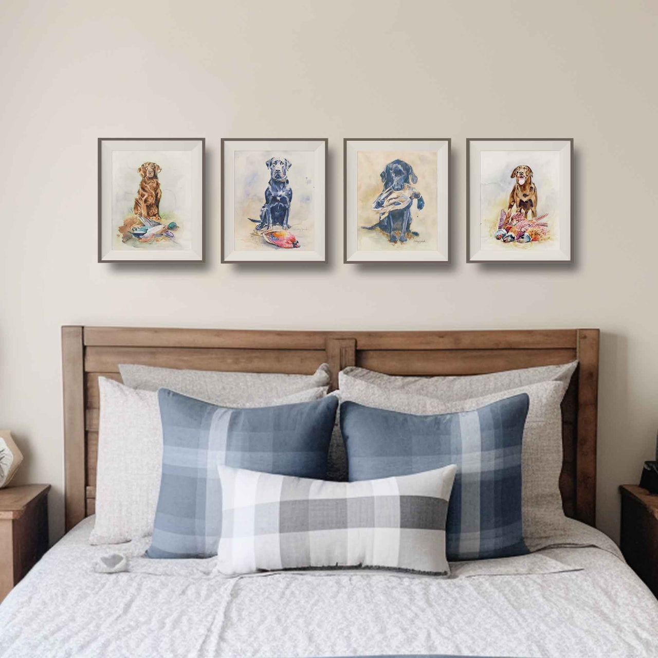 lifestyle mockup of 4 hunting dog watercolor prints- 2 chocolate labs and 2 black labs, matted and framed over a teen boys bed