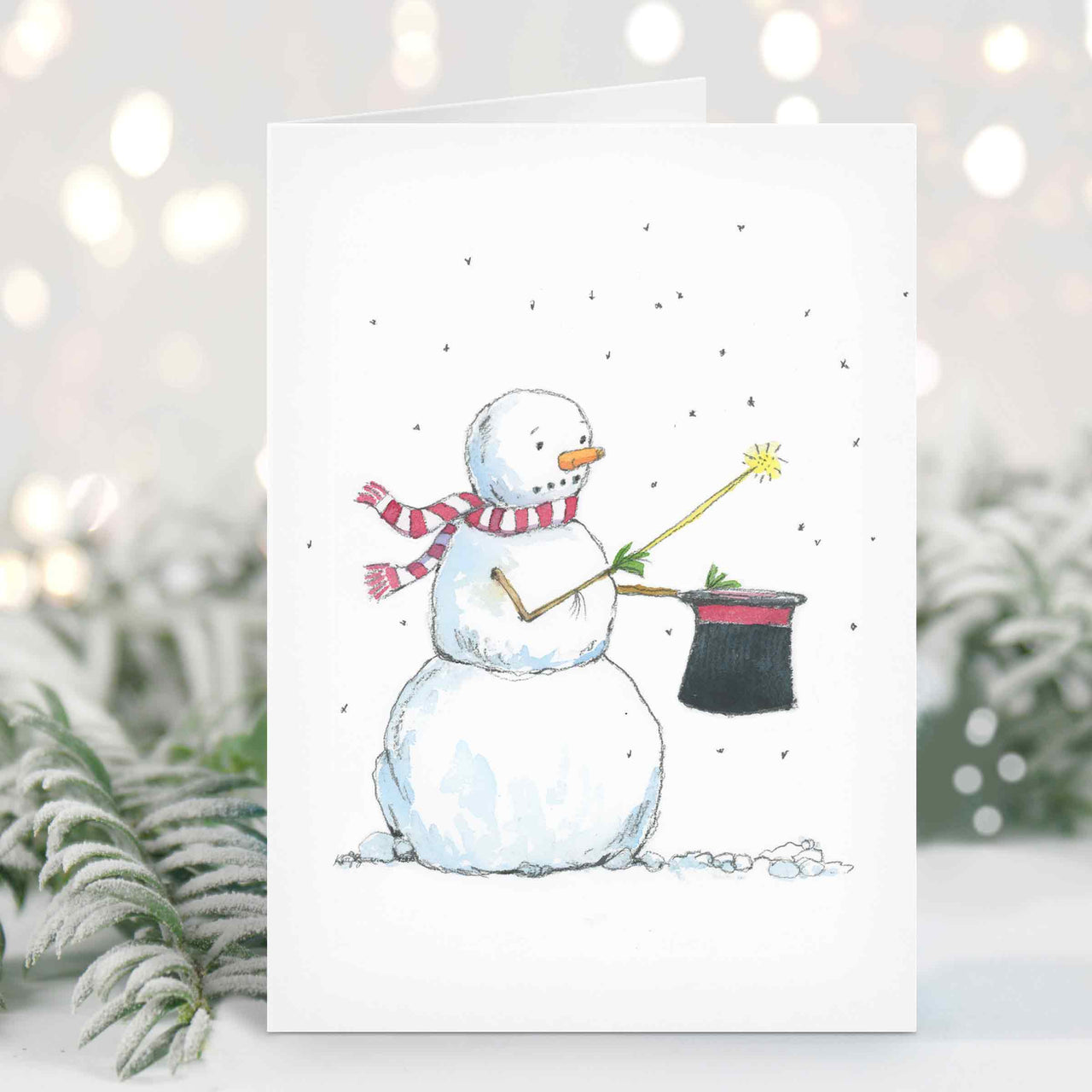 a card with a snowman holding a broom