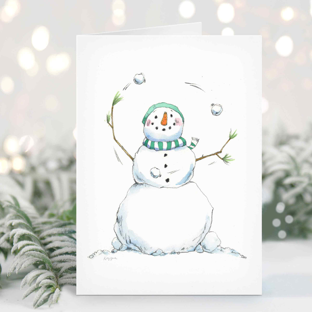 a card with a snowman holding a branch