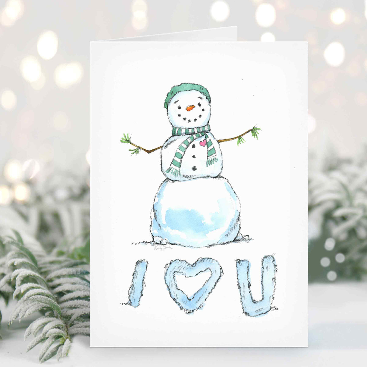 a card with a watercolor snowman on it