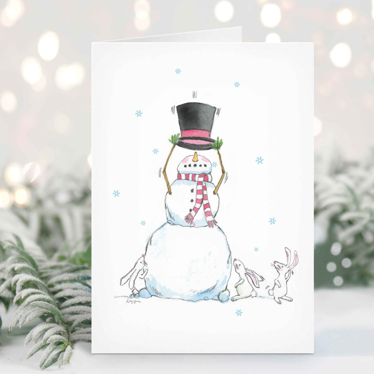 a snowman with a top hat and scarf