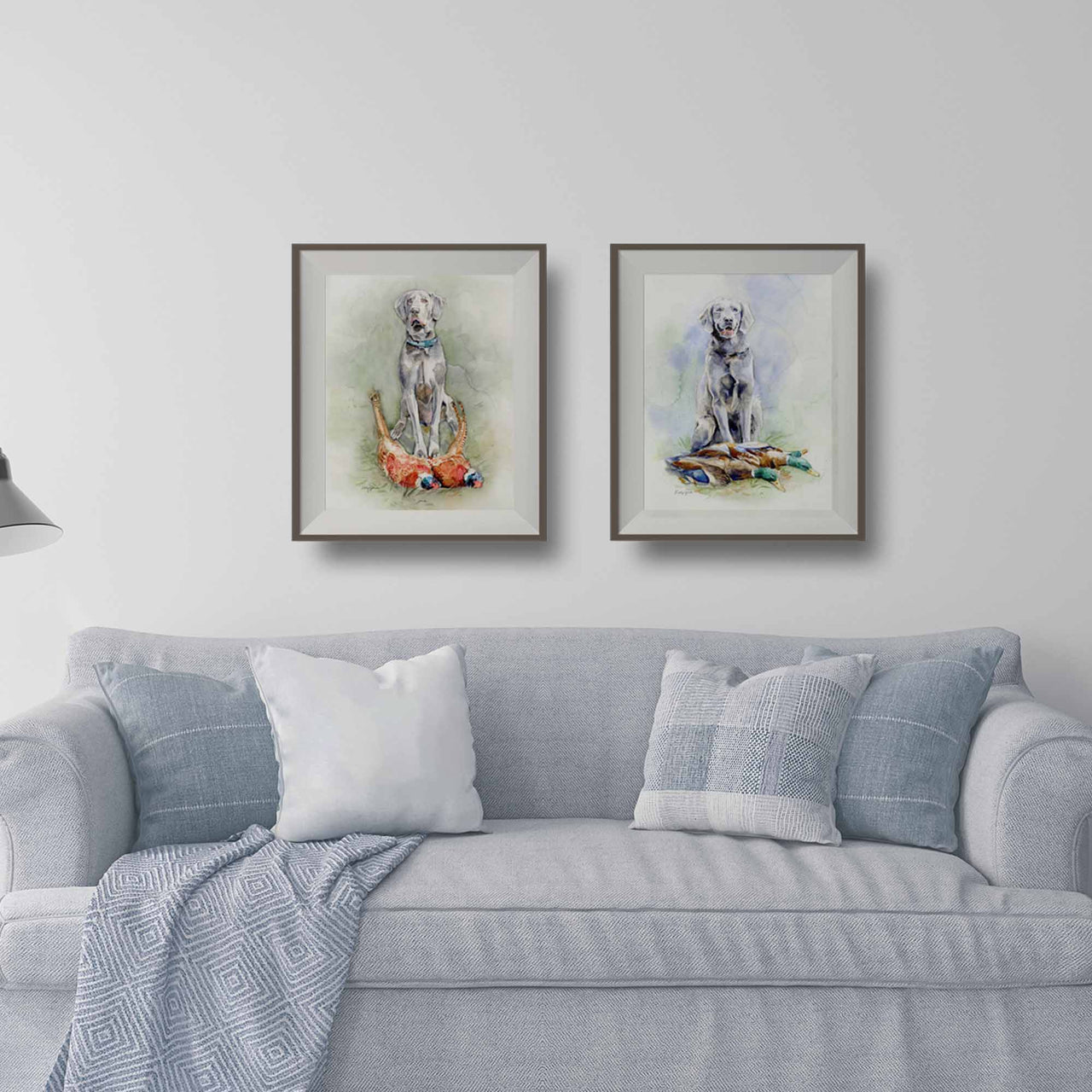 lifestyle mockup of two silver lab retriever matted and framed prints over a gray couch
