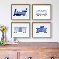 Thumbnail for Four framed watercolor train illustrations arranged in a 2x2 grid on a white wall above a wooden cabinet. The prints show a blue steam locomotive, a dairy tank car, a gray boxcar, and a blue caboose, each in a light wood frame.