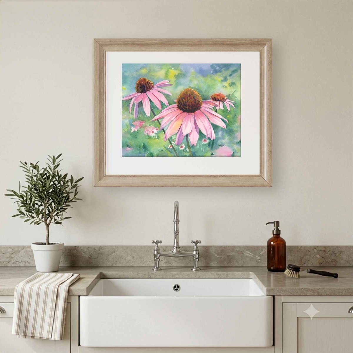 Original artwork of pink flowers above a kitchen sink with a plant and soap dispenser.