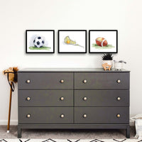 Thumbnail for Three framed prints of soccer ball, lacrosse stick and ball and football in a boys room.