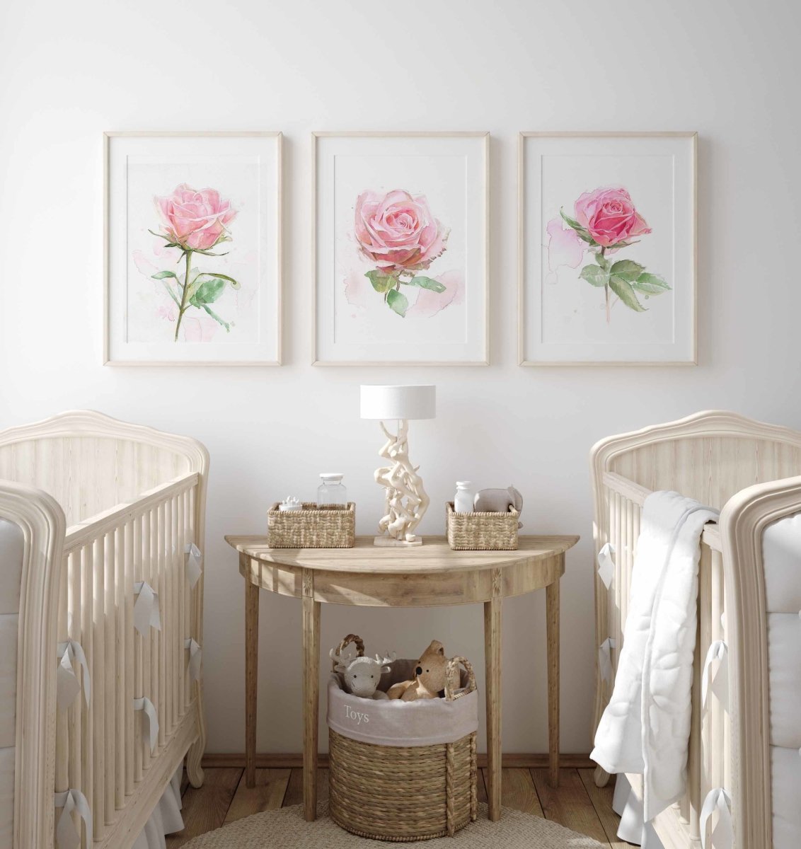 set of three pink rose prints in a baby's nursery