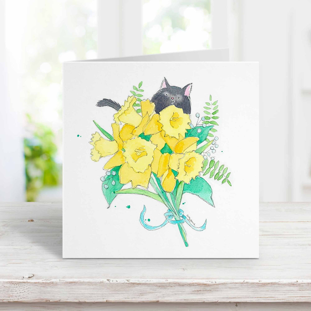 black cat with daffodils greeting card